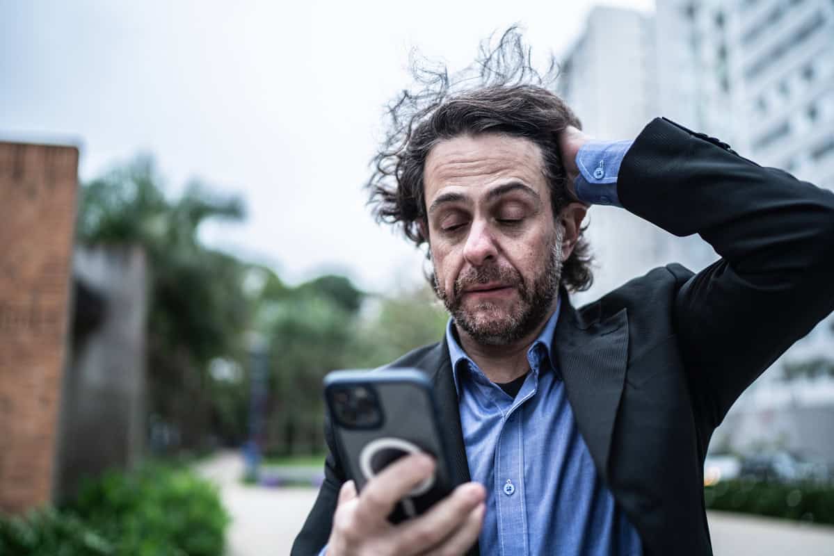 man looks worried about something on his phone