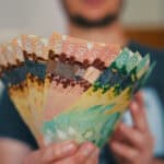 Person holds banknotes of Canadian dollars